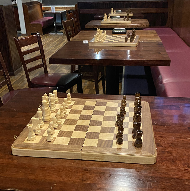 Tables with chess boards at Brews and Cues in Flagstaff Arizona